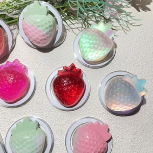 Macro detail of strawberry-shaped resin Magsafe grips with vibrant color gradients