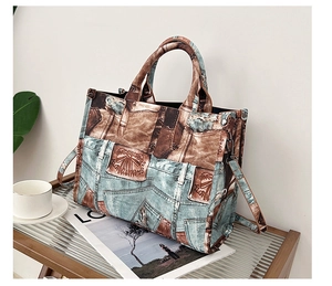 Vintage patchwork tote bag with brown handles and strap on a wooden tray detail