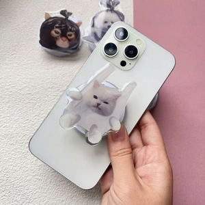 Cute acrylic cat phone grip with retractable MagSafe design on white smartphone