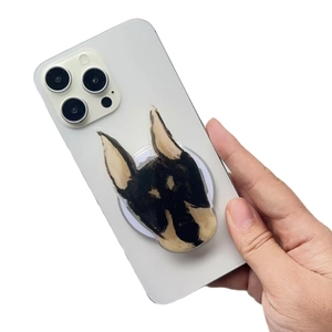 Cute hand-drawn dog acrylic phone grip stand on a white smartphone back view