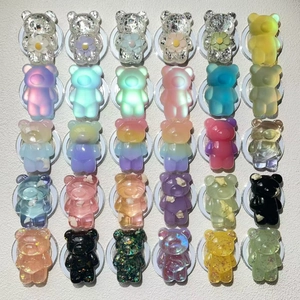 Macro view of 30 assorted glitter and resin gummy bear phone grip accessories set