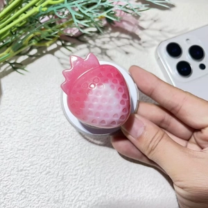 Detailed view of MagSafe strawberry grip with pink gradient resin texture and seed details