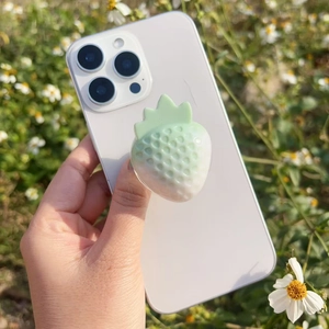 Detailed macro view of a 3D resin strawberry phone grip with gradient texture