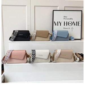 Multiple stylish crossbody bags with colorful woven straps and premium textures