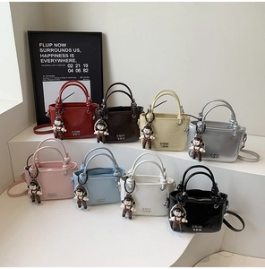 Detail view of retro oil wax leather bucket bags in eight vibrant colors with cute charms