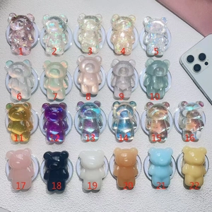 Detailed view of 22 cartoon bear magnetic phone sockets in various laser and glitter finishes