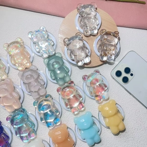 Cute colorful bear magnetic phone grips in diverse resin styles on wooden tray