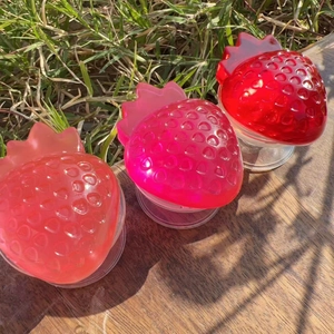 Macro detail of strawberry-shaped resin phone grips with vibrant gradient colors