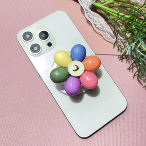 Detail of colorful flower phone socket with heart icon on a white smartphone