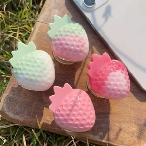 3D resin strawberry phone grip socket in colorful gradient finish on wooden background