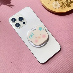 Close-up of cute cartoon bear phone socket with blue bow on white smartphone