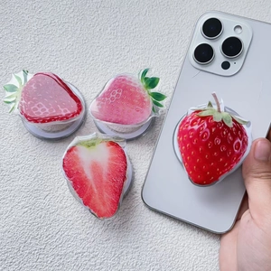 Detail view of various strawberry phone grips with 3D acrylic resin finish