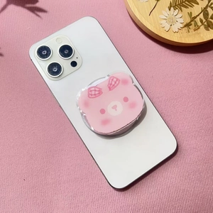 Close-up of pink cartoon bear phone griptok with cute grid pattern on a white smartphone