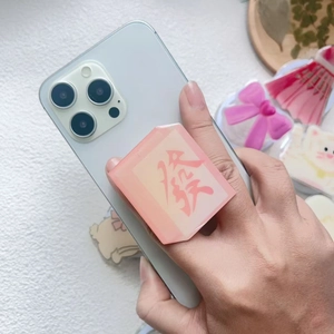 Pink resin Mahjong 'Fa' magnetic phone grip holder on iPhone with aesthetic accessories