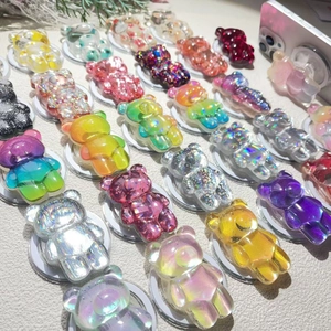 Macro view of assorted resin bear phone grips with glitter and gradient finishes