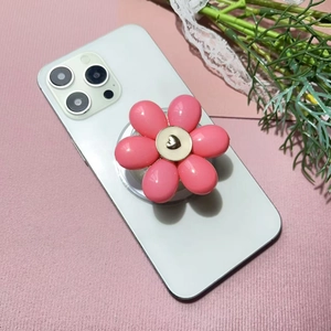 Macro view of 3D pink floral phone socket with gold heart center on a smartphone