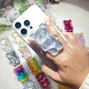 Macro shot of colorful glitter resin bear phone socket stand with magnetic suction feature