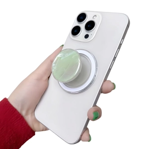 Close-up of marble pattern magnetic phone socket grip on the back of a white smartphone