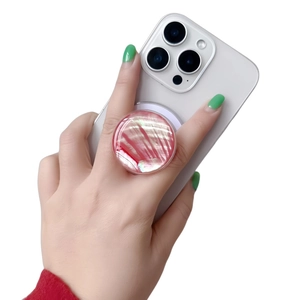 Detail of red and white mother-of-pearl phone grip socket on a white smartphone