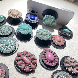 Flat lay of bohemian retro turquoise phone grips with vintage silver metal frames