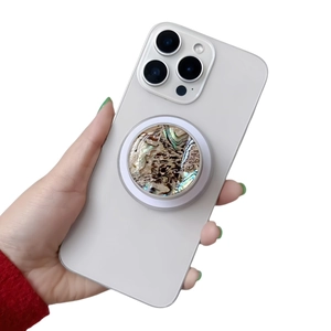 Close-up of a shimmering mother-of-pearl phone grip holder on a white smartphone