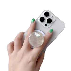 Close-up of mother-of-pearl phone socket holder on white smartphone held by hand