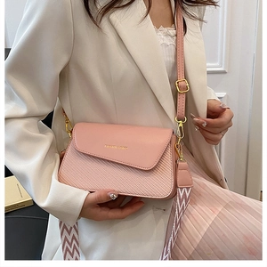 Detail of pink leather and woven crossbody bag with stylish dual shoulder straps