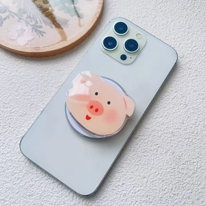 Close-up of a cute 3D pink pig acrylic phone grip holder attached to a mobile phone