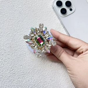 Detail of luxury rhinestone phone socket with colorful crystal gems and Magsafe magnet