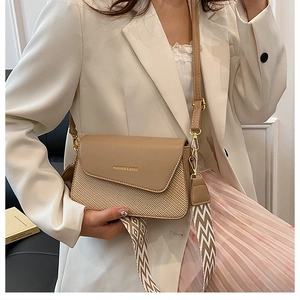 On-body view of square shoulder bag with woven texture and dual strap options