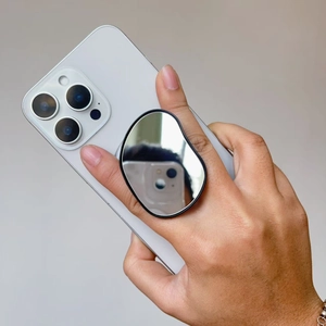 Magnetic retractable phone grip with oval mirror finish and ergonomic hand hold design