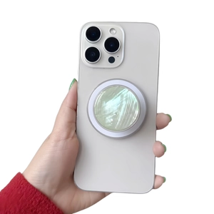 Detailed macro of a green mother-of-pearl phone grip holder with magnetic attachment