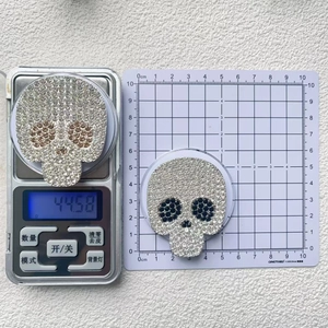 Detailed scale view of a rhinestone skull phone socket showing weight and 6cm height