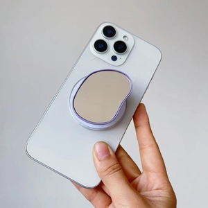 Detail showing retractable purple magnetic circle mirror phone stand on a white device