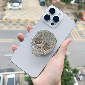 Detailed close-up of a glittering skull-shaped popsocket with sparkling rhinestones