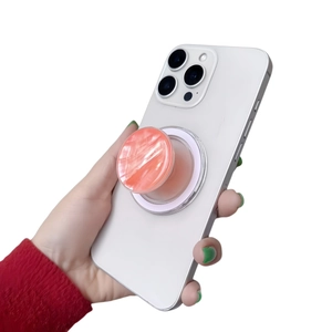 Detail of pink marble Magsafe phone socket stand attached to a white smartphone