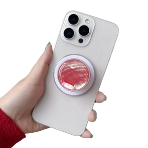 Detail shot of a round marble texture phone socket grip on a white smartphone back