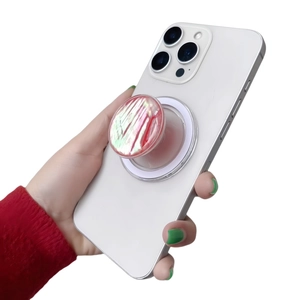 Detail of red and white marble-textured mother of pearl phone grip on a white smartphone