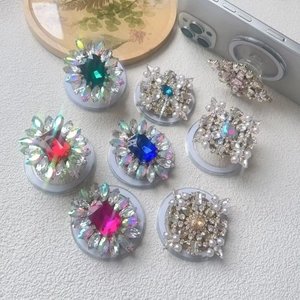 Luxury rhinestone and pearl magnetic phone socket stand with various colorful gems