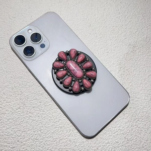Detail of pink faux turquoise floral phone grip with silver alloy finish on a smartphone