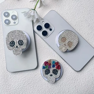 Close-up of sparkling rhinestone skull phone sockets with detailed floral embellishment