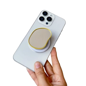 Yellow magnetic mirror phone socket holder for iPhone on handheld white smartphone