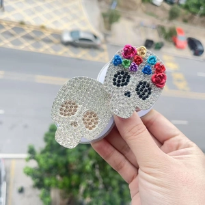 Skull magnetic phone grip fully encrusted with clear rhinestones and colorful flower accents