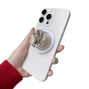 Macro view of a phone grip featuring iridescent abalone shell texture and foldable design