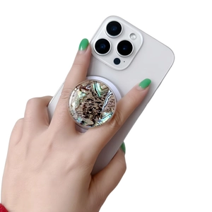 Detail of magnetic phone socket with iridescent mother of pearl texture on white base