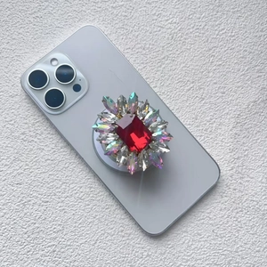 Detailed shot of a floral phone socket with a large red gemstone and aurora rhinestones