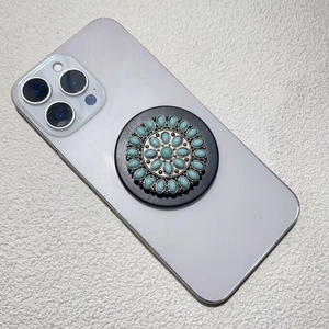Detail shot of a bohemian flower-patterned phone socket with green turquoise stones