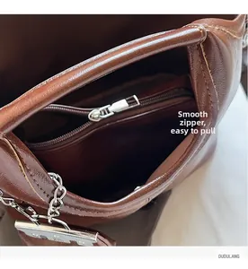 Detail shot of the smooth silver zipper and interior lining of the vintage tote bag