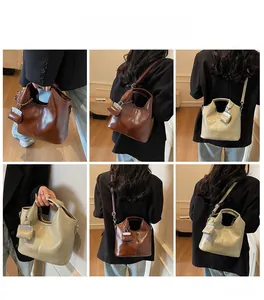 Detail of vintage oil skin tote with matching mini pouch in dark brown and light beige