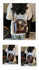Detail of vintage brown oily leather tote bag with small detachable coin purse accessory